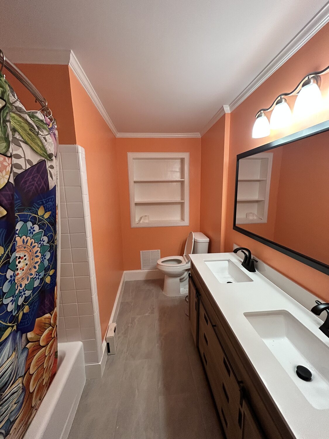 Completed FIG bathroom remodel — double vanity and tub, terracotta walls