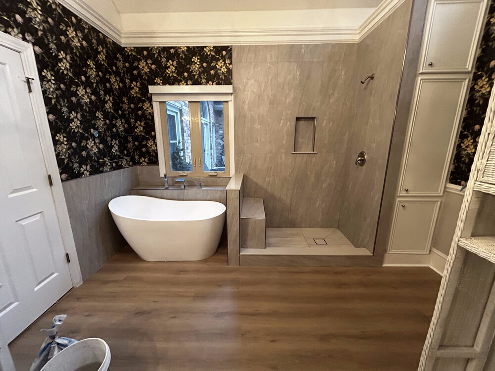 Completed FIG bathroom remodel — freestanding tub, wallpaper accent