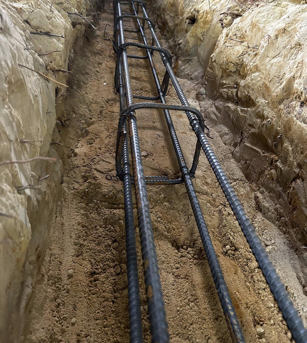 Completed FIG foundation — tied rebar cage in footing trench
