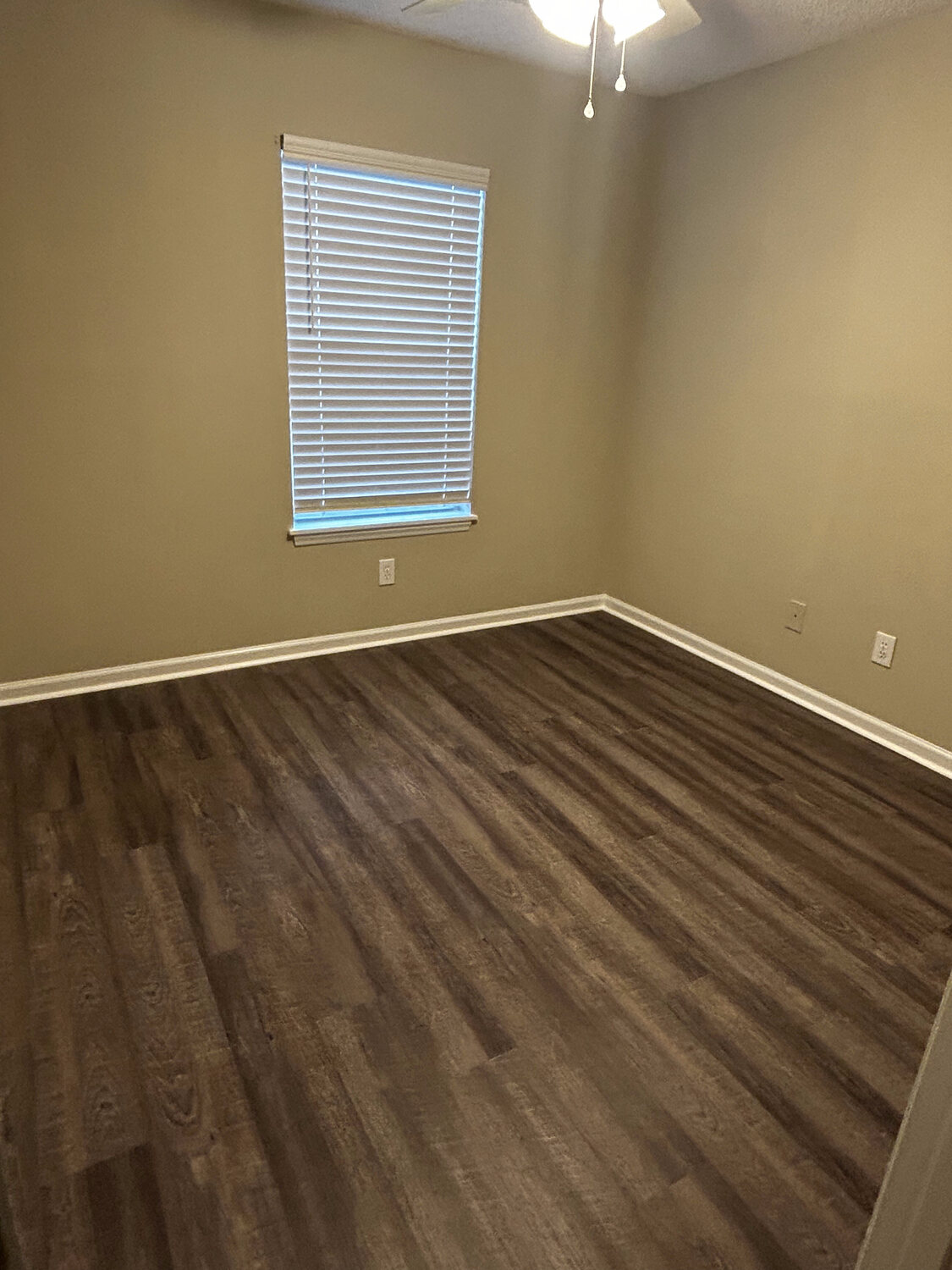 Completed FIG LVP wood-look flooring — bedroom