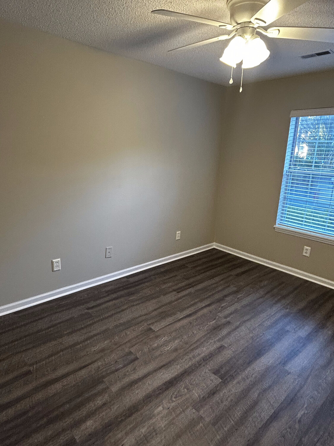 Completed FIG LVP wood-look flooring — living room