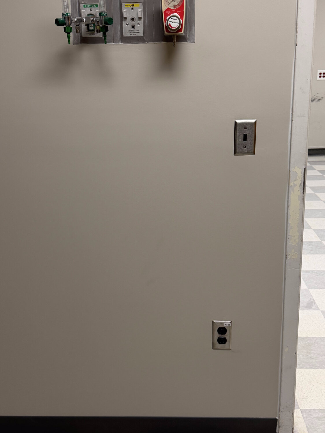 FIG medical facility interior — finished exam room wall