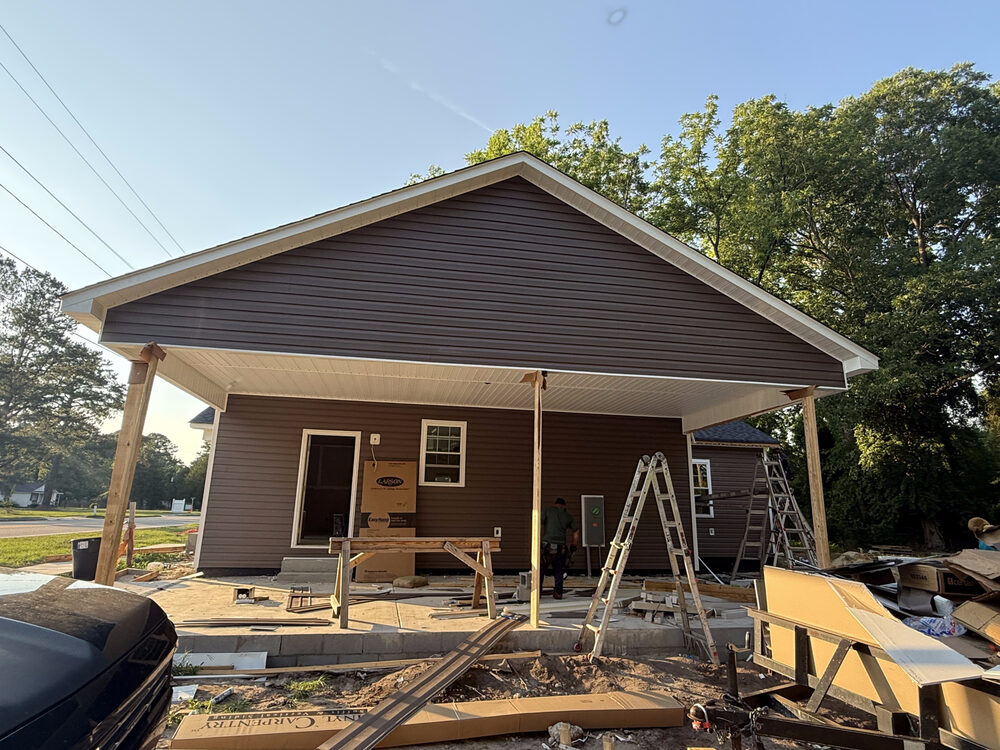 Completed FIG exterior — covered porch and siding